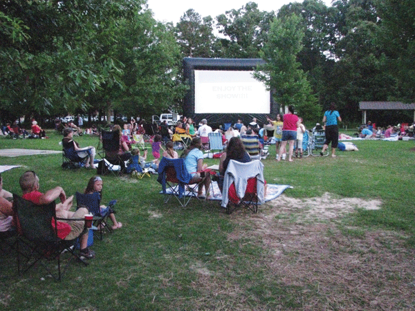 An assembly of villagers getting ready to watch a movie in Braselton GA.